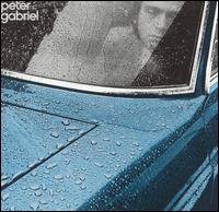 Image of man seated in car in rain