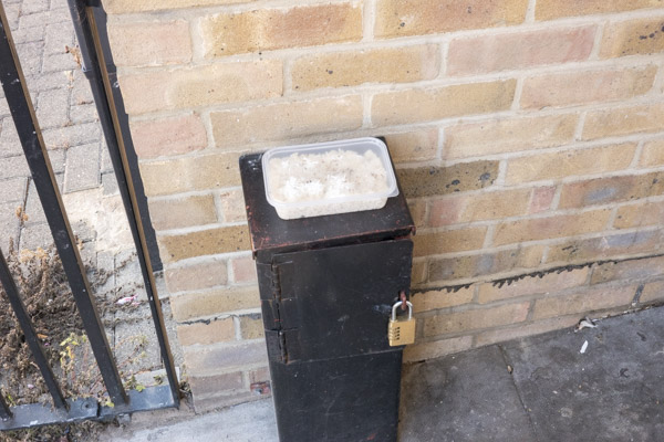 a pair of cheap silver high heeled shoes lie discarded in the doorway