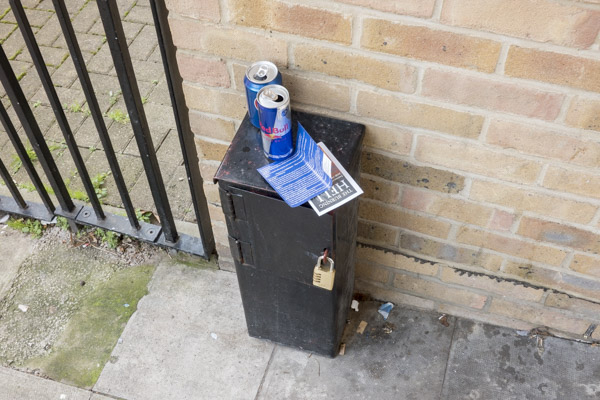 a pair of cheap silver high heeled shoes lie discarded in the doorway