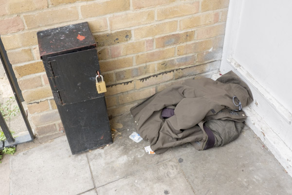 a pair of cheap silver high heeled shoes lie discarded in the doorway
