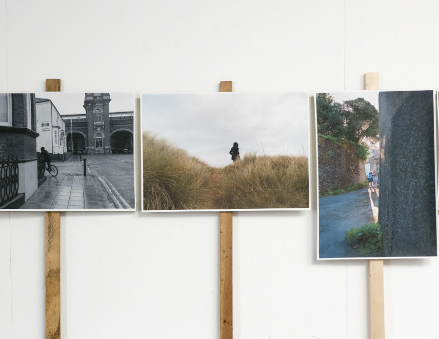 an oblique view from the right of the grid of multilayered images pinned to the white wall